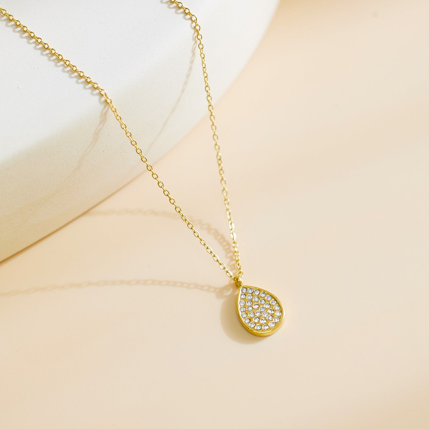 Necklace with oval shape pendant with stones.