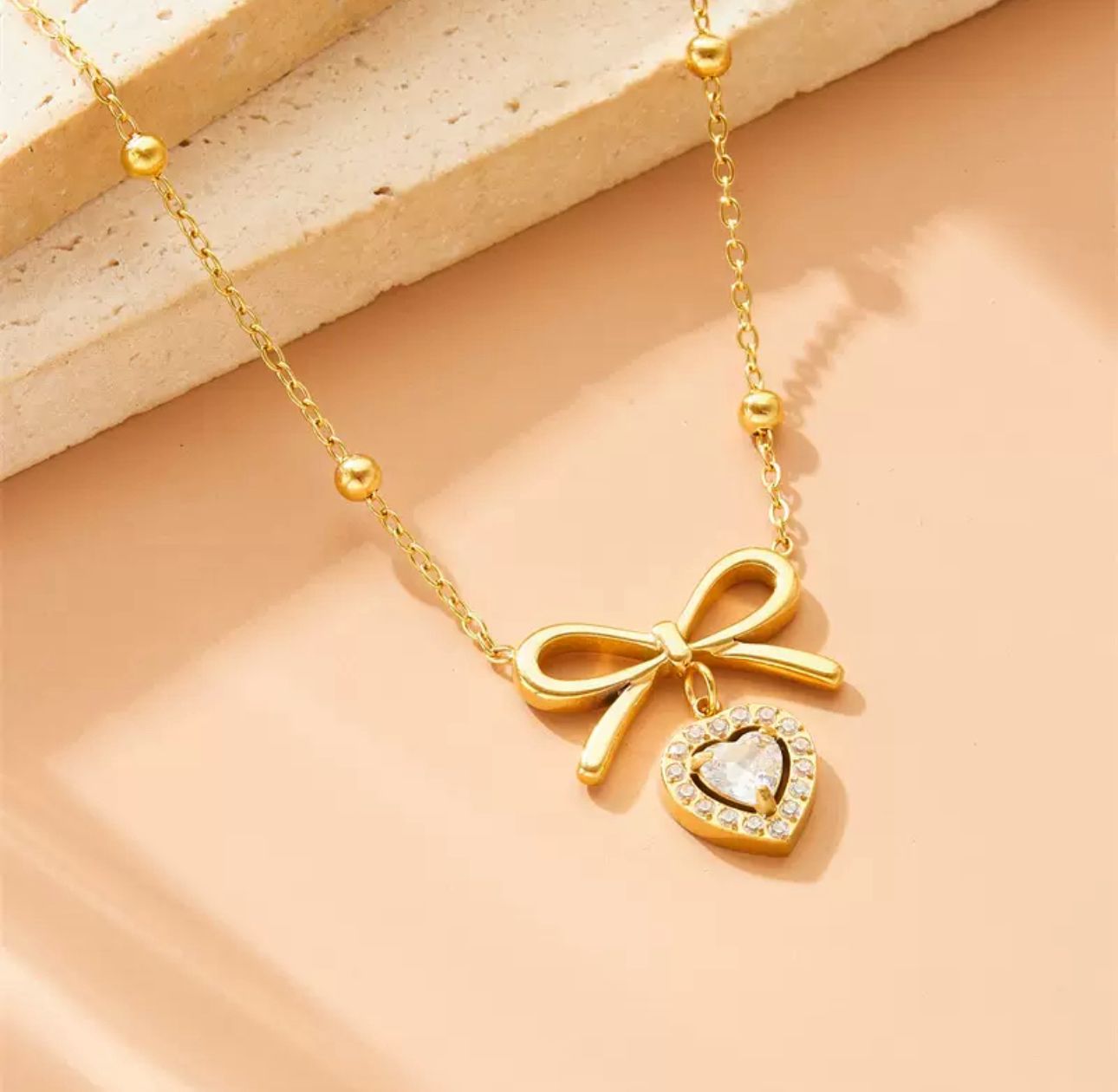 Heart and bowtie pendant necklace