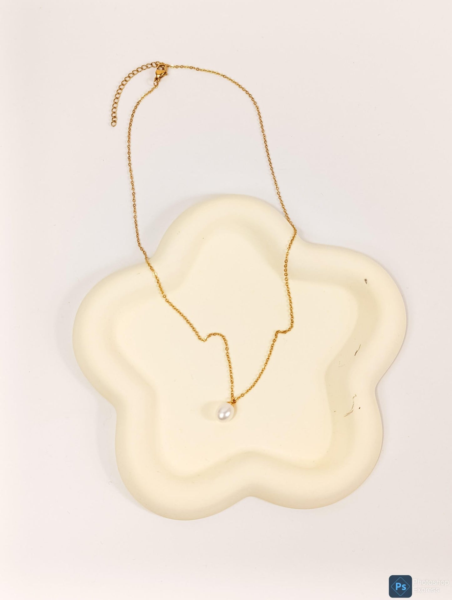 Necklace with pearl pendant.