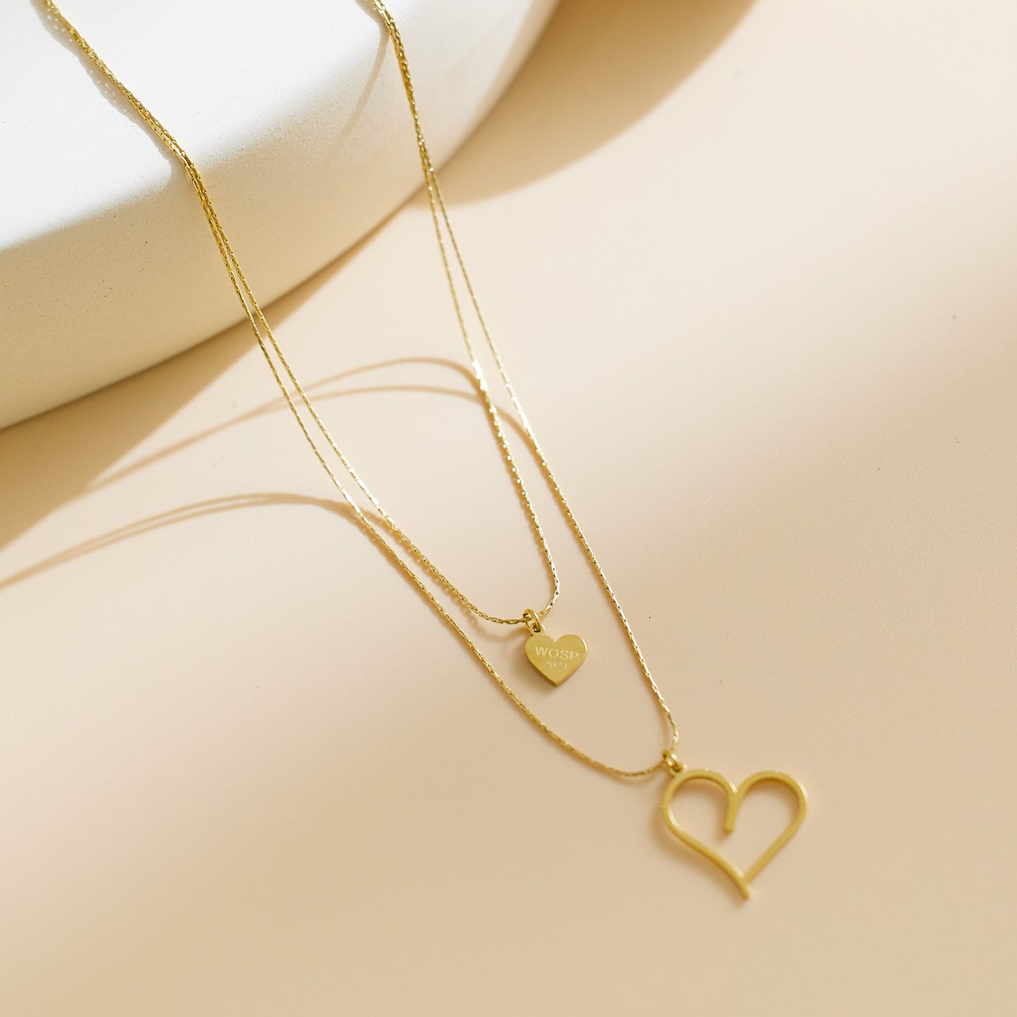 Double layered necklace withheart pendants on both chains