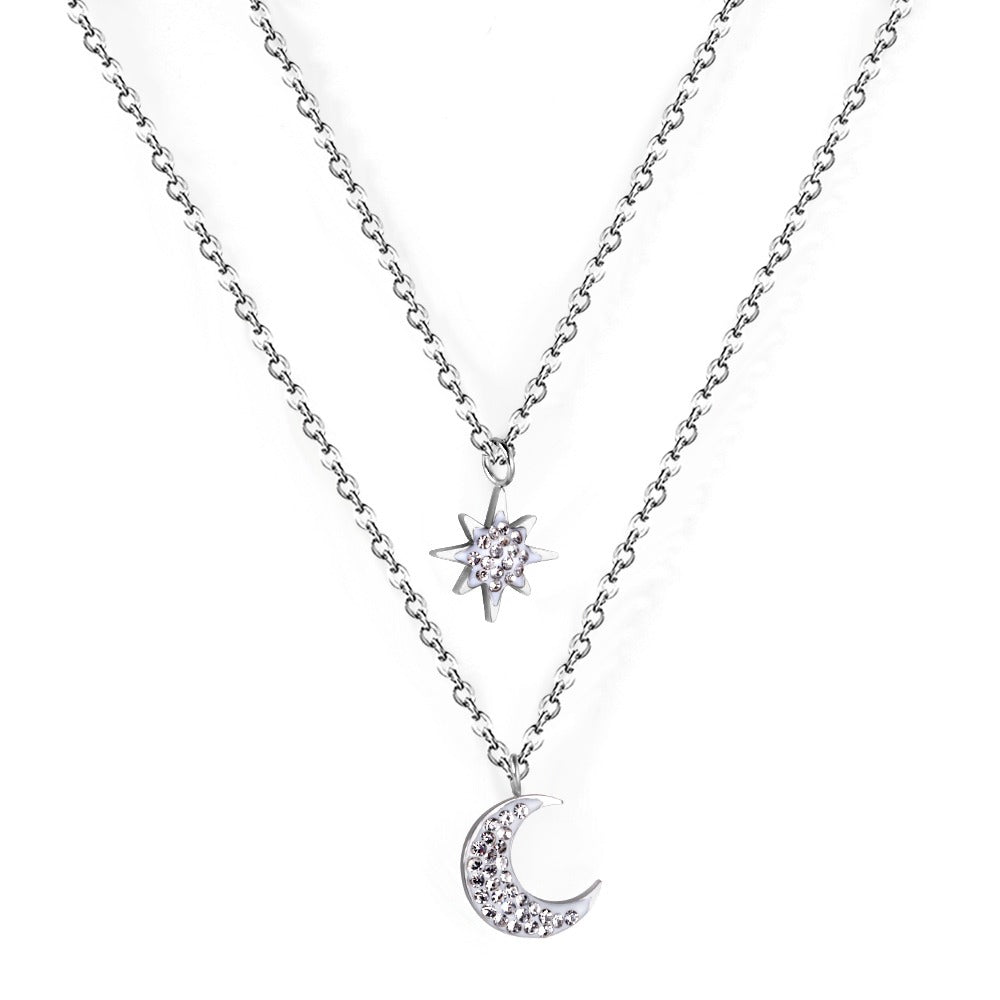 Double layered silver necklace with moon pendant in inner chain and star pendant in outer chain