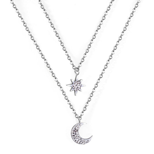 Double layered silver necklace with moon pendant in inner chain and star pendant in outer chain