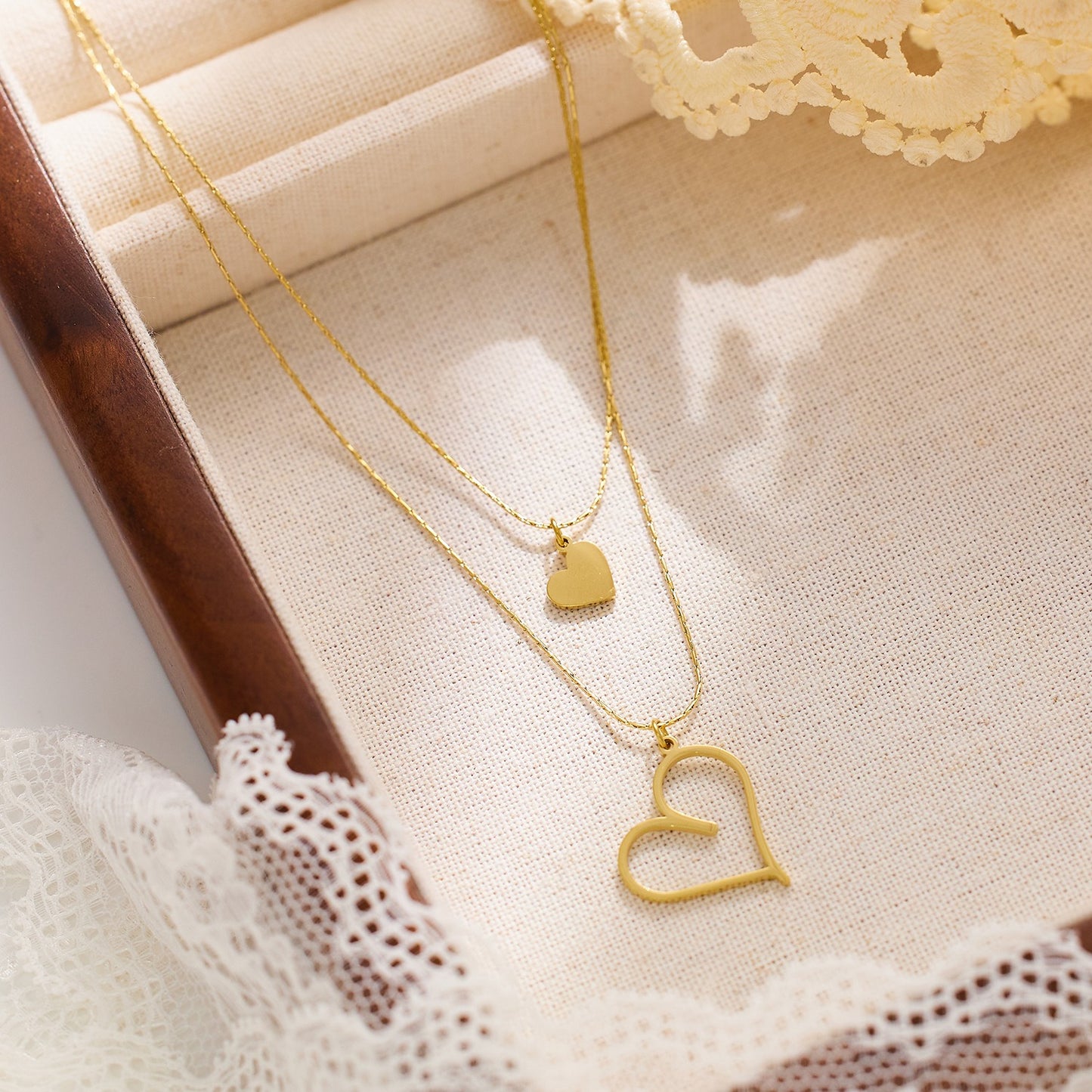 Double layered necklace withheart pendants on both chains
