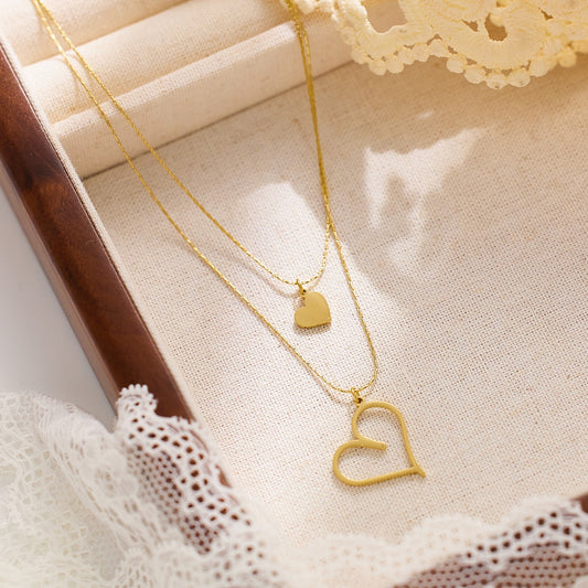 Double layered necklace withheart pendants on both chains