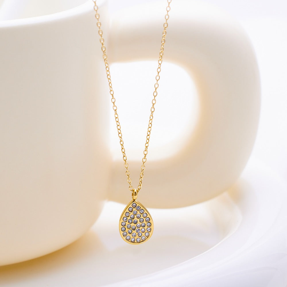 Necklace with oval shape pendant with stones.