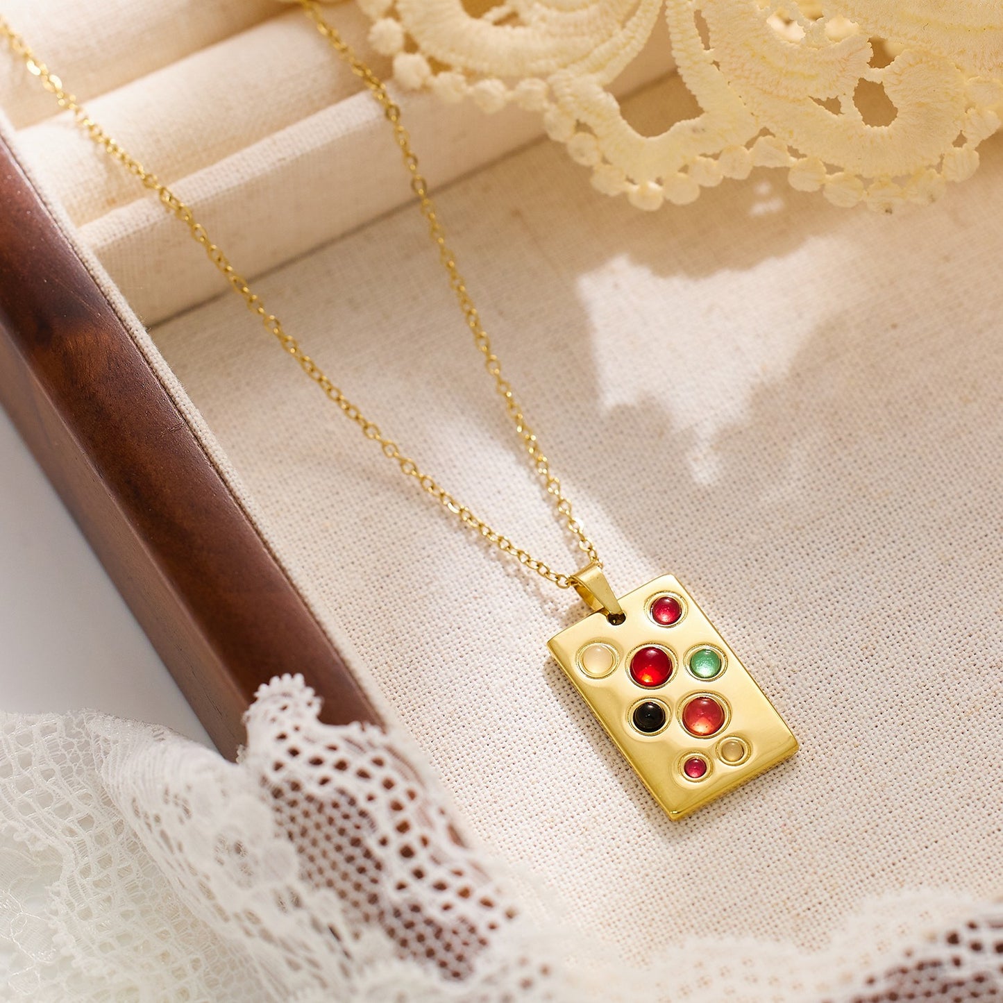 Necklace with rectangular pendant with various color stones