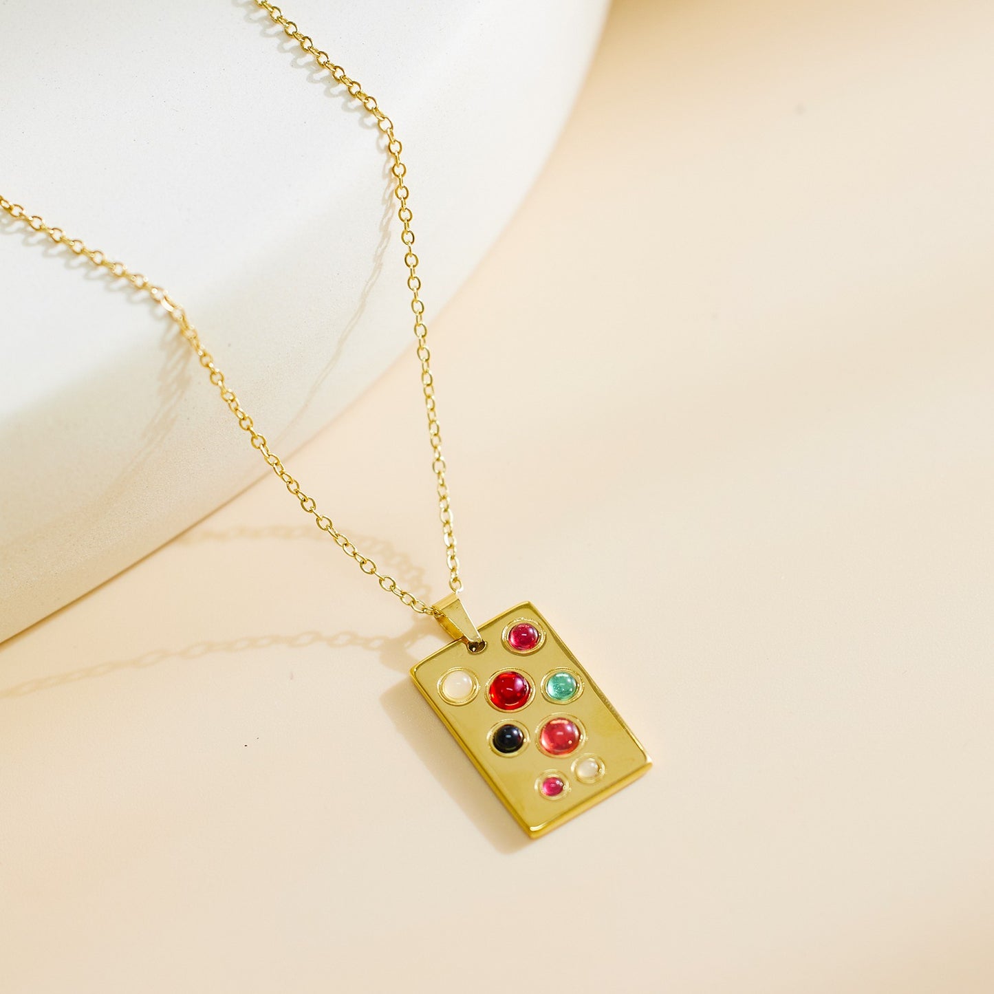 Necklace with rectangular pendant with various color stones