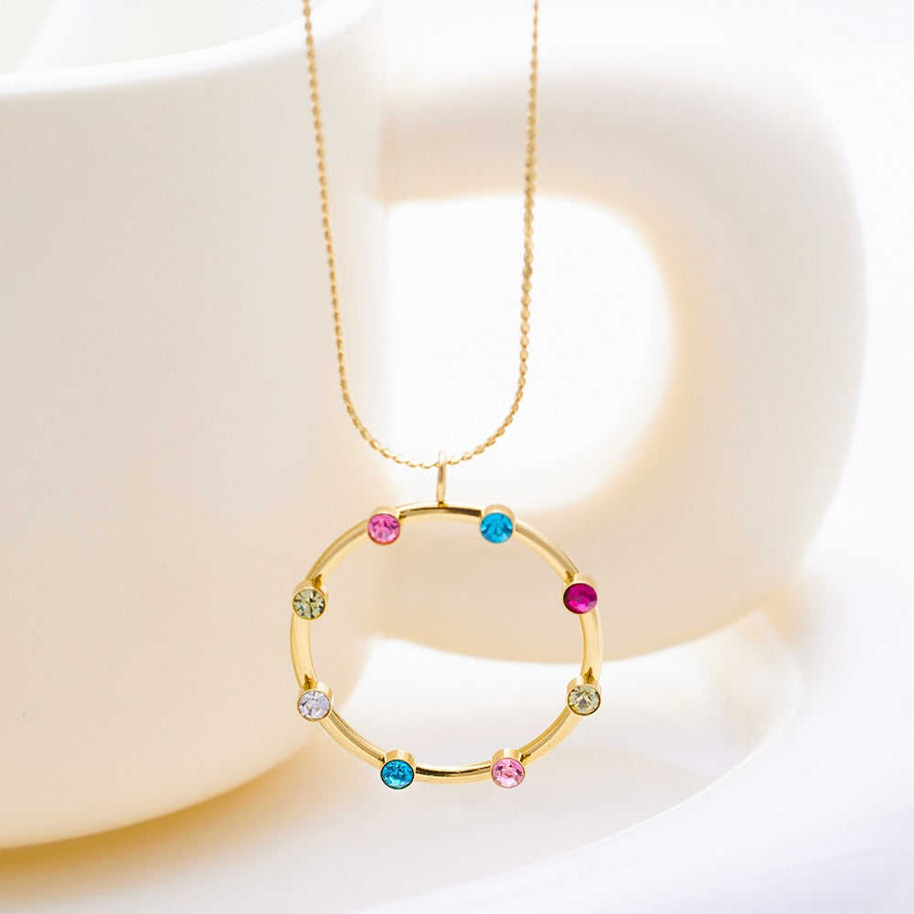 Necklace with a circle shaped pendant with various color stones