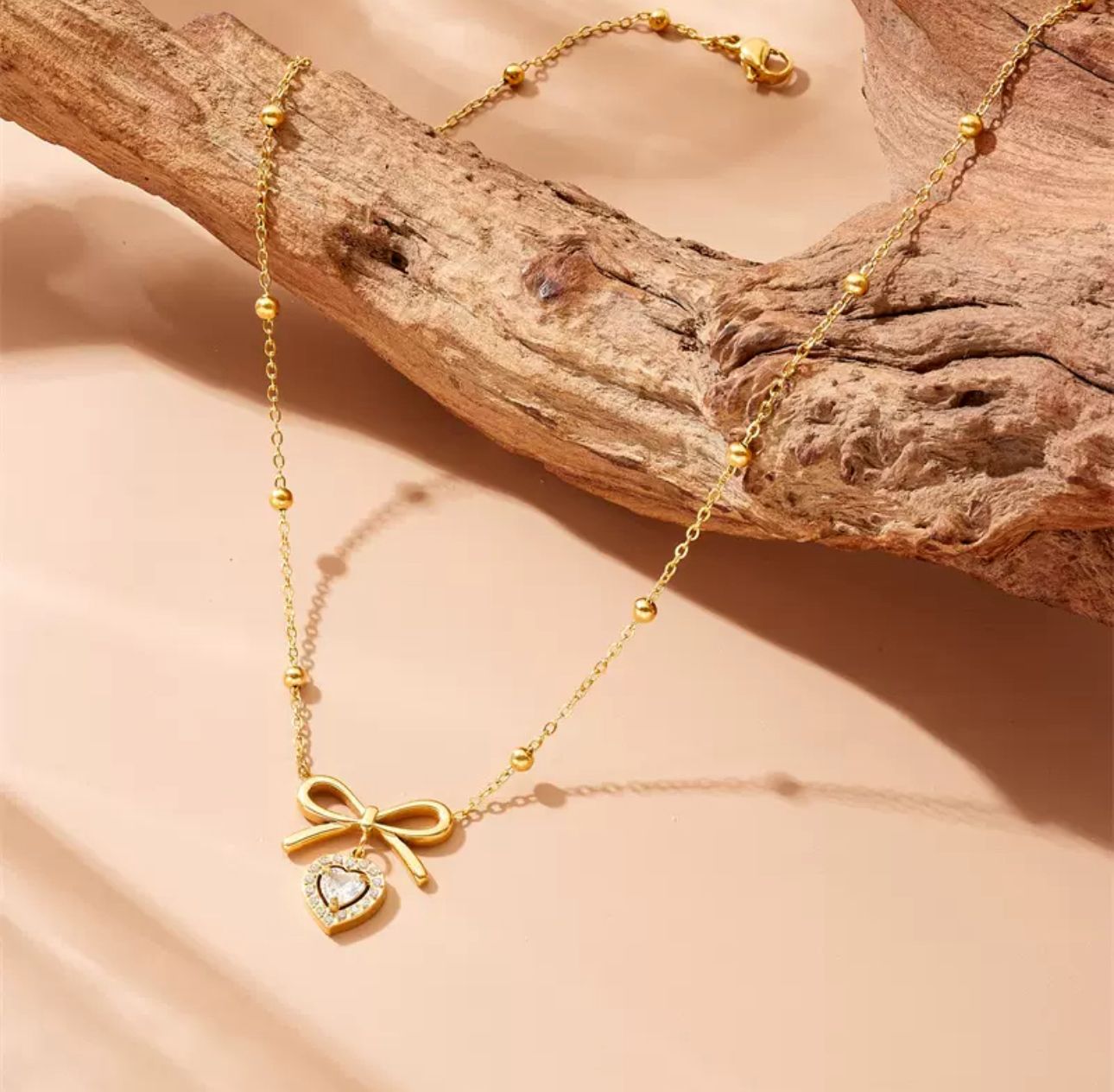 Heart and bowtie pendant necklace