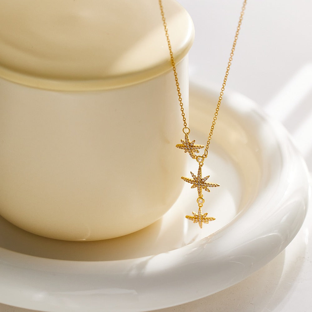 Necklace with elongated chain design and 3 stars pendant with stones