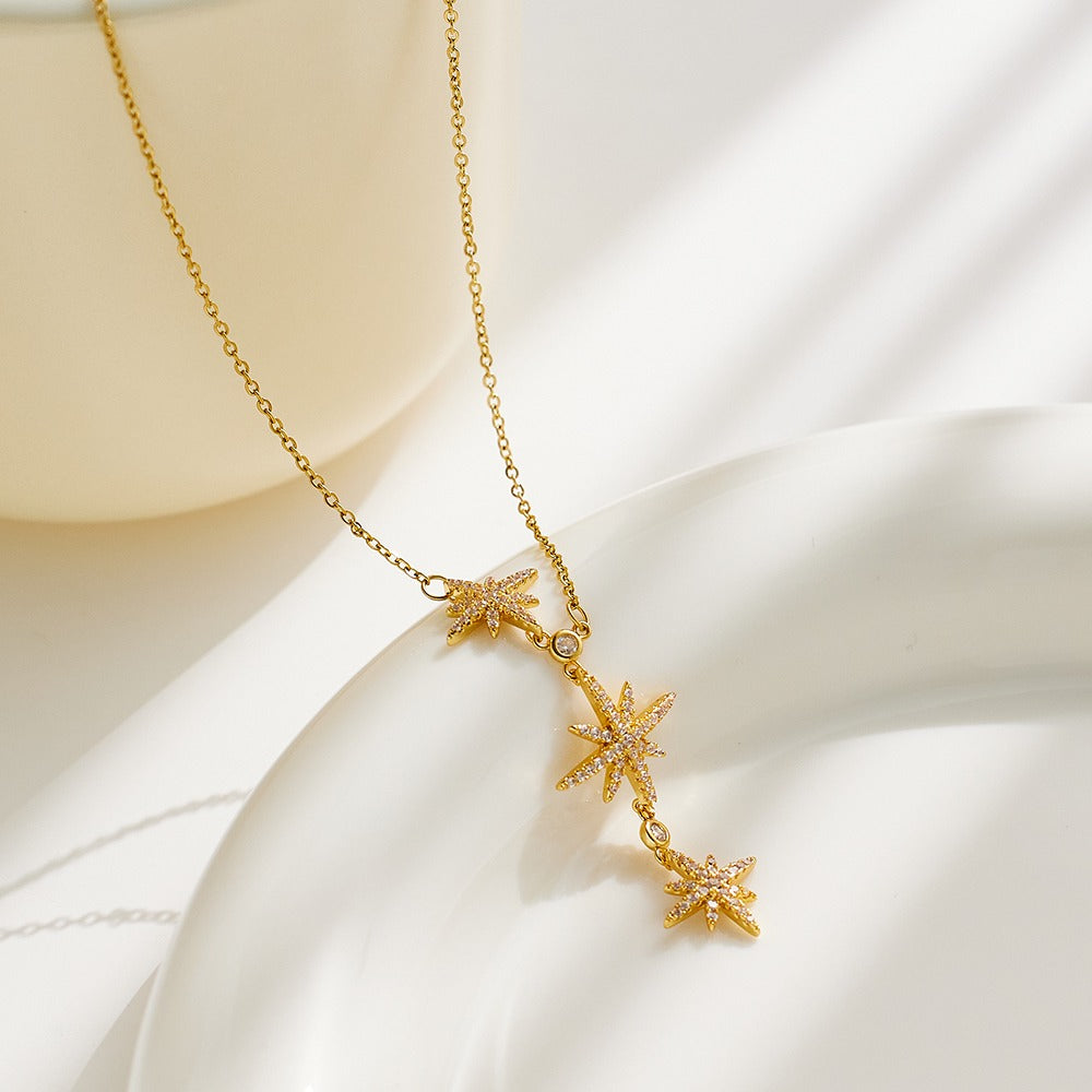 Necklace with elongated chain design and 3 stars pendant with stones